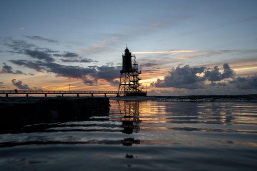 The historic lighthouse Obereversand over a calm sea in the evening in Germany