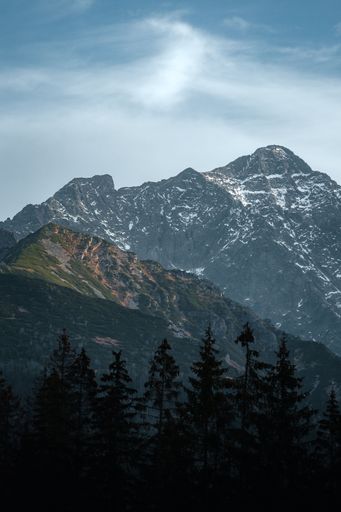 A scenic view of mountain range against a blue sky background