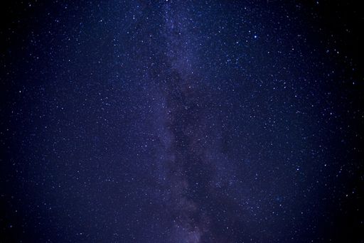 A low angle shot of a galaxy sky filled with stars at night time