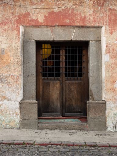 A vertical shot of a wooden door of an old building