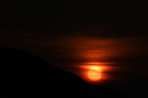 A solar eclipse during a colorful sunset