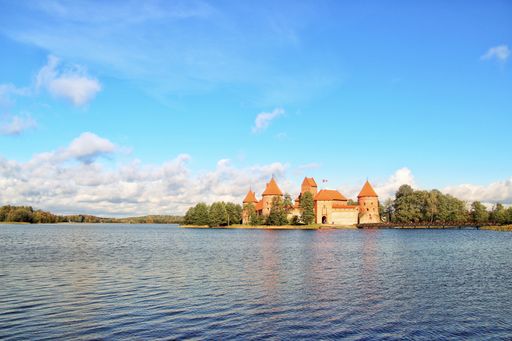 The historic Trakai Castle in Lithuania near the lake under the beautiful cloudy sky