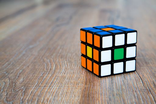 A closeup of a colorful cube toy on a wooden surface