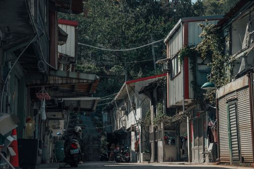 A street with village buildings and a motorcyclist on his bike in Matsu, China