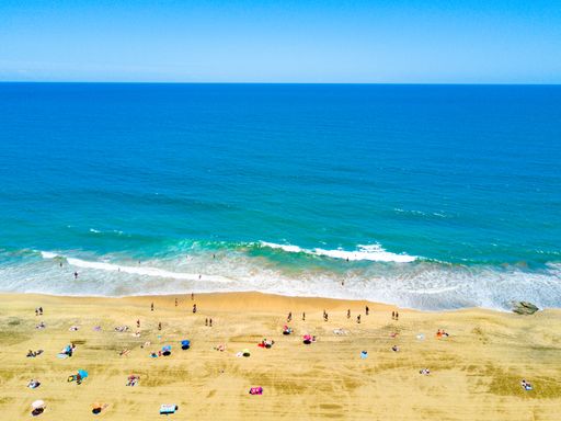 An aerial view of the beach by the Atlantic ocean and Maspalomas dunes in Gran Canaria, Spain