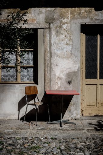 A nice frontyard in Ticino, Switzerland (italian part of Switzerland) where the sun was shining on a chair and a table.