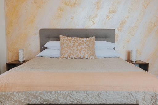 A close-up shot of a bed in an interior of a bedroom