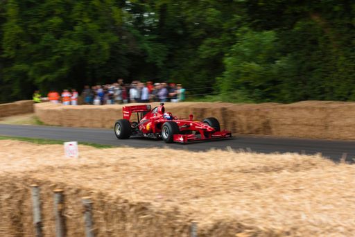 An old Ferrari Formula 1 car going up the hill climb