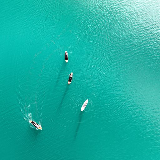 A bird's eye view of the people relaxing on the fishing boats in Lake Bled, Slovenia