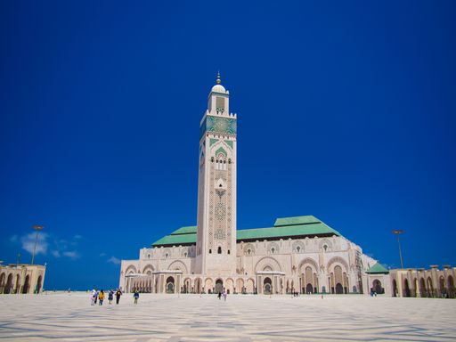 A tall minaret and huge arches decorates the Grand Hassan II Mosque with the huge sliding roof fully open in Casablanca, Morocco