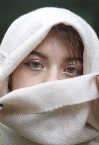 A vertical closeup of the woman's face with beautiful grayish-green eyes.