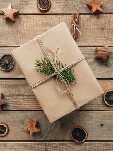Top view of christmas present and decorations on wooden boards