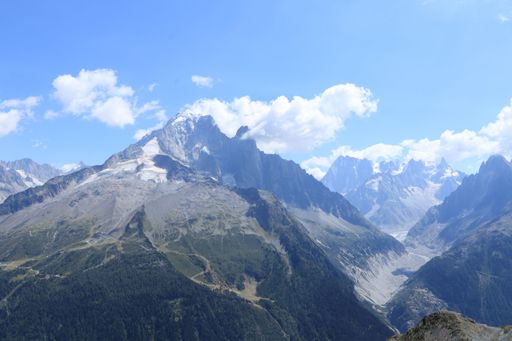 An aerial view of the beautiful Mont Blanc mountains under a bright blue sky