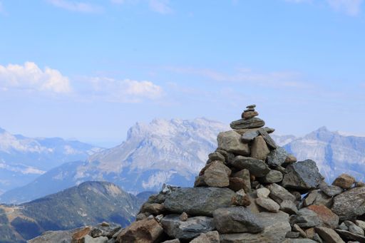 A stack of rocks overlooking the view of the Mont Blanc Mountains in Europe