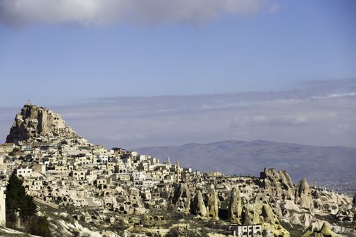 A high angle shot of Uchisar castle in Cappadocia, Turkey under the cloudy sky