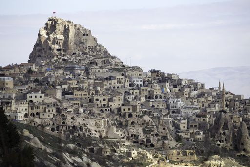 A high angle shot of Uchisar castle in Cappadocia, Turkey under the cloudy sky