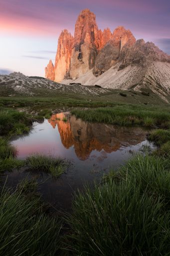 The Drei Zinnen in the Dolomites at sunset with a reflection
