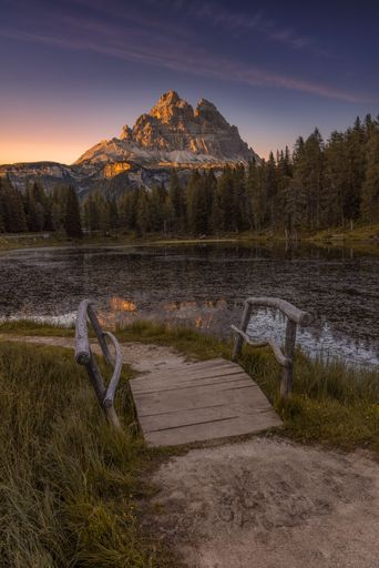A Bridge with mountain in the background at sunset in the Dolomites