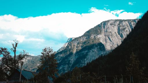 A drone shot of the mountains under the cloudy sky seen from Hallstatt village in Austria