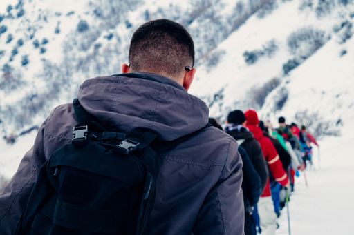 Group of people hiking in snowy mountains