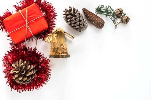 The Christmas ornaments, pine cones, and gifts isolated on a white background with space for text