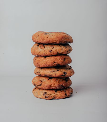 A closeup of stacked chocolate cheap cookies on gray background