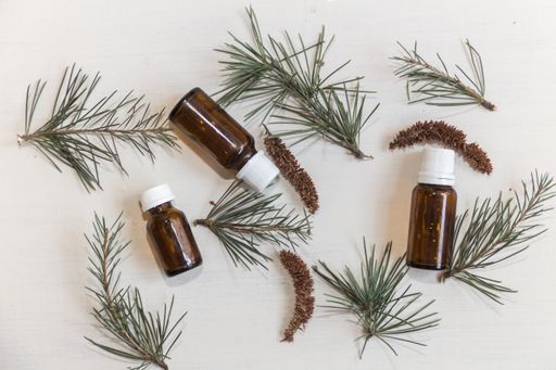 Top view bottles with cedar oil. Aromatherapy and natural cosmetics concept background