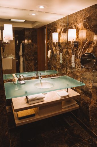 A vertical shot of a bathroom sink and mirror