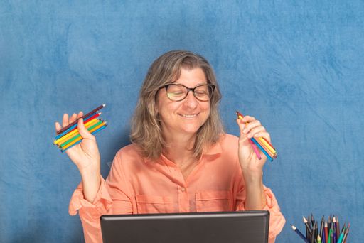 Happy woman with laptop computer working from home or office. Business, people and technology concept.