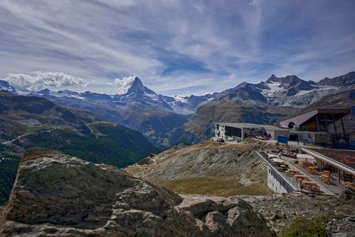 The Gornergrat rocky mountain ridge and the starting point of the gondola ride under a cloudy sky, Switzerland