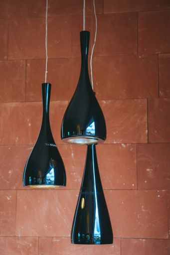 A vertical shot of three ling black lamps
