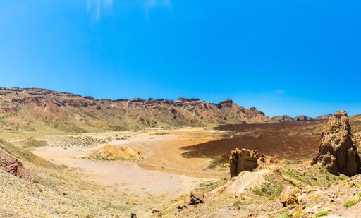 A spot in Tenerife with many rocks and a beautiful mountain landscape in the background