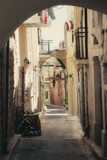 A vertical shot of a narrow alley in the streets of Samothrace in Greece on a sunny day