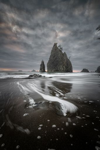 A vertical shot of the cliffs at Rialto Beach on a cloudy day. Olympic National Park, Washington, USA.