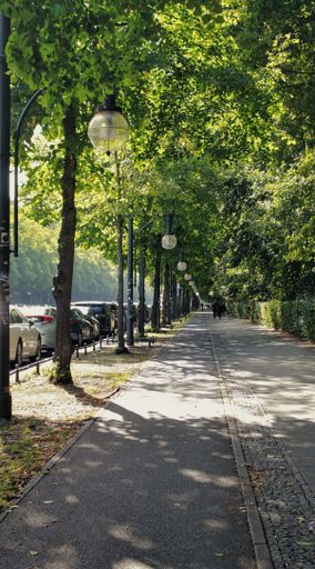 A natural view of a walkway in a park in Berlin, Germany
