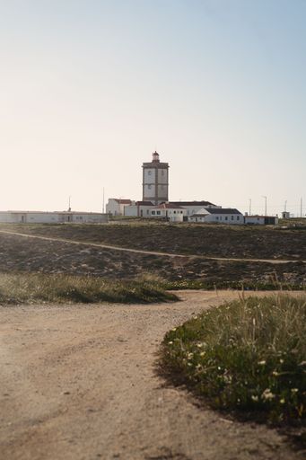 A vertical shot of a lighthouse on a sunny day in Peniche, Portugal