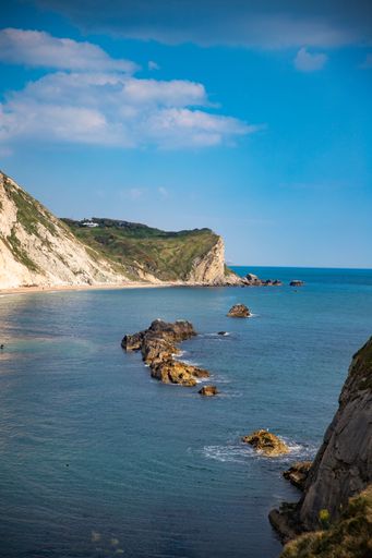 A vertical shot of the ocean with a beautiful coast