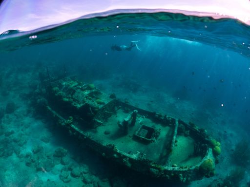 A closeup view of a tugboat and crystal clear waters