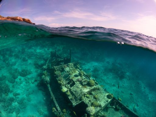 A closeup view of a tugboat and crystal clear waters