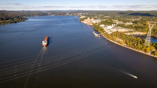 An aerial view over a red and rusty oil tanker n the Hudson River, in New York on a sunny day