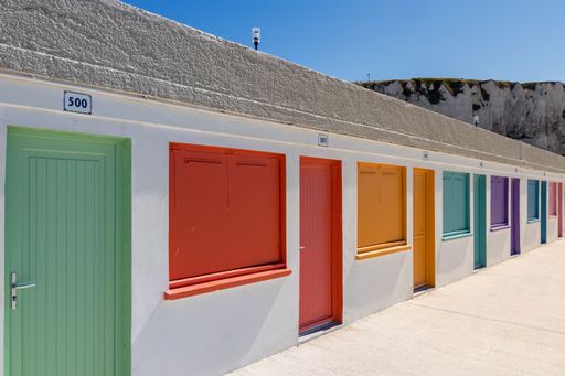 some colorful beach cottages in summer under blue sky