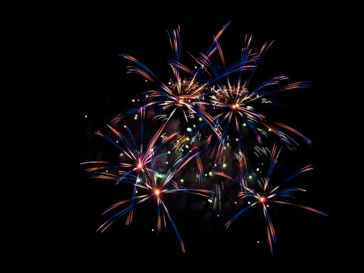 A scenic shot of the colorful fireworks against the night sky background