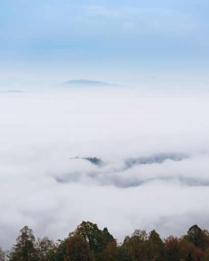 A vertical shot of the morning fog and clouds over the valley