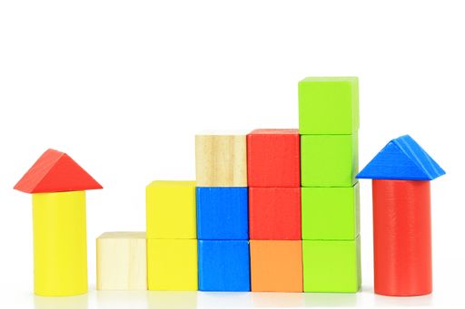 A closeup of colorful wooden blocks for children on a white background
