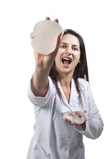 A vertical shot of a female doctor offering a silicone for breast Implant on white background
