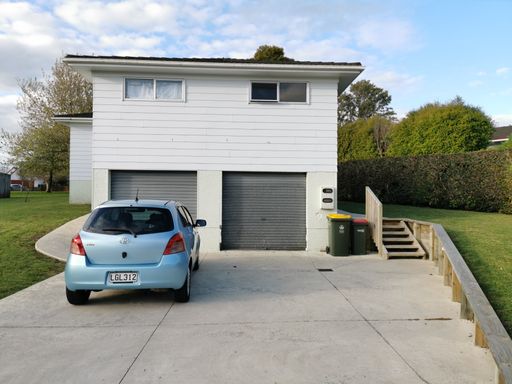 Auckland / New Zealand - September 24 2020: View of Toyota Echo parked in front of suburban house with garage