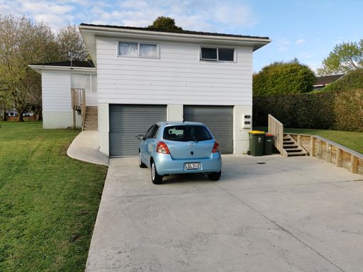 Auckland / New Zealand - September 24 2020: View of Toyota Echo parked in front of suburban house with garage