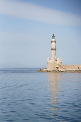 A vertical shot of the white Lighthouse of Chania by the sea in Chania, Crete, Greece