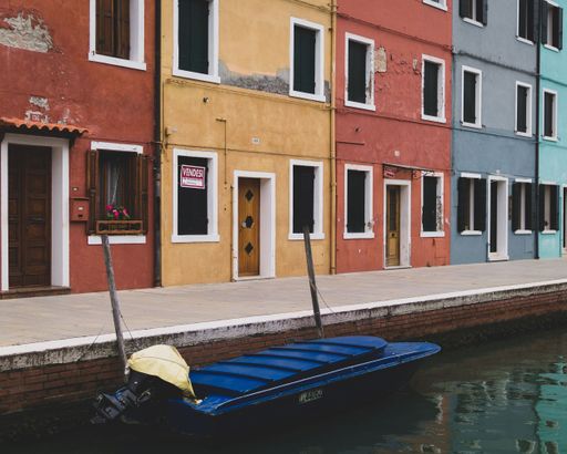 Colorful buildings along a canal with a moored boat