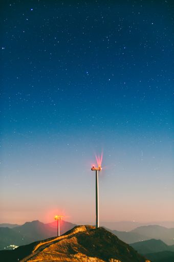 A vertical shot of wind power generators under the starry night sky in Rongshui County Liuzhou China